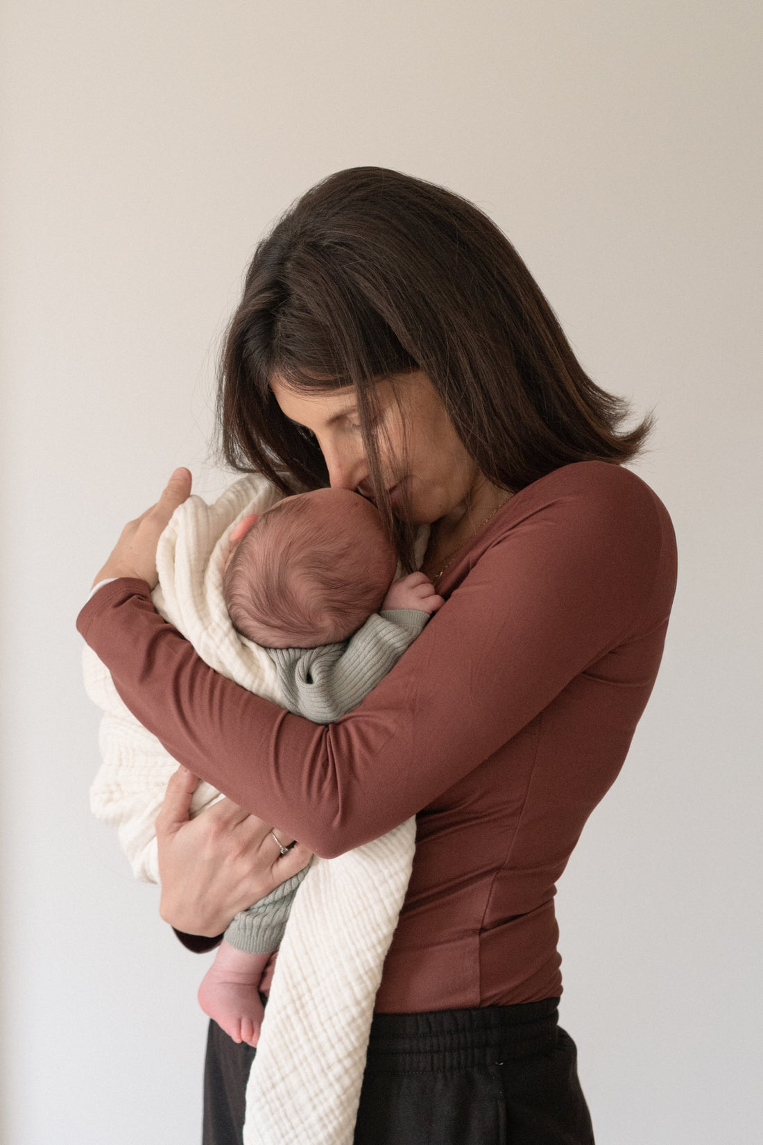 women holding baby, smiling