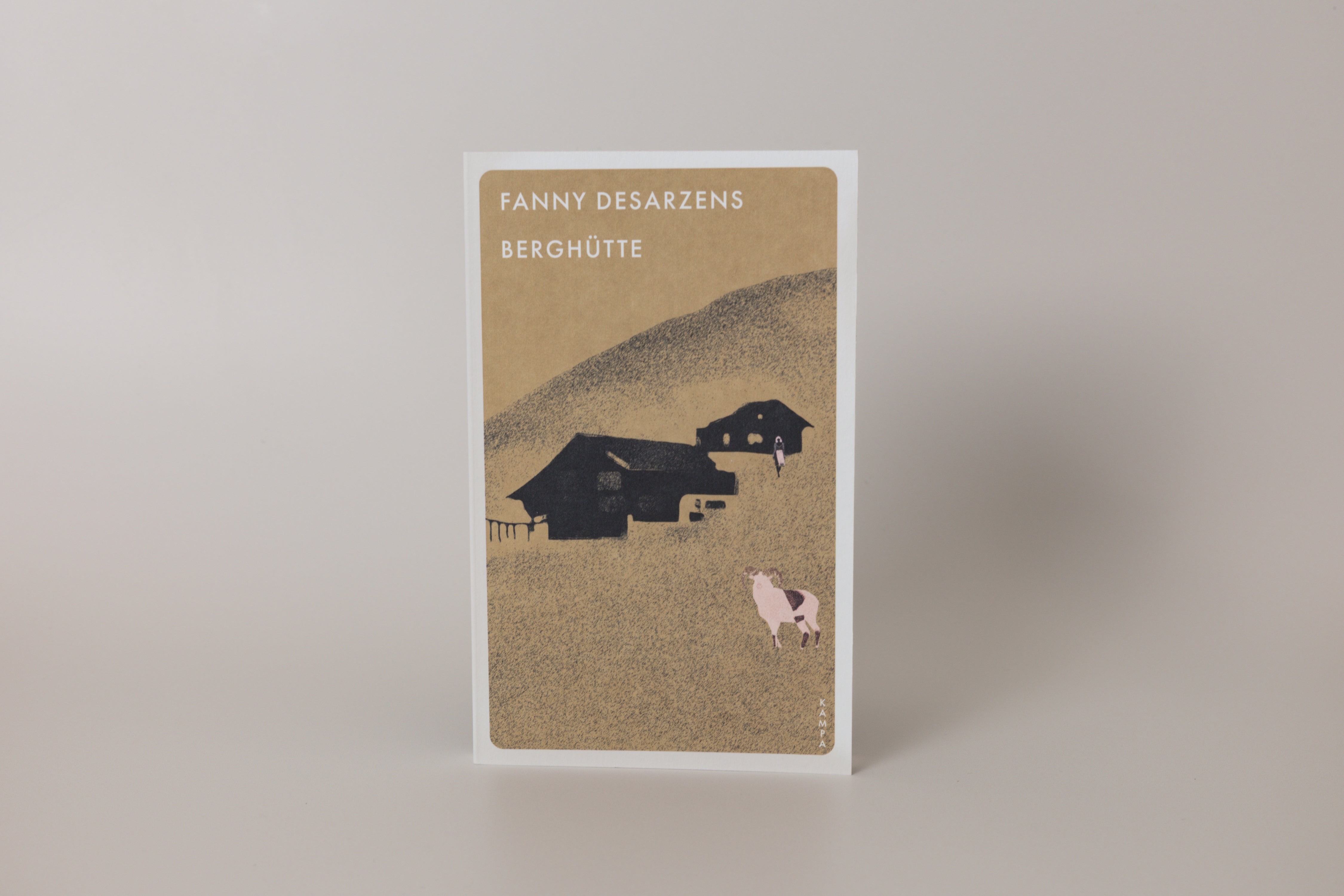 Book cover with illustration of a house and cow on a beige background