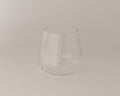 Clear glass tumbler on a beige background