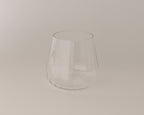 Clear glass tumbler on a beige background