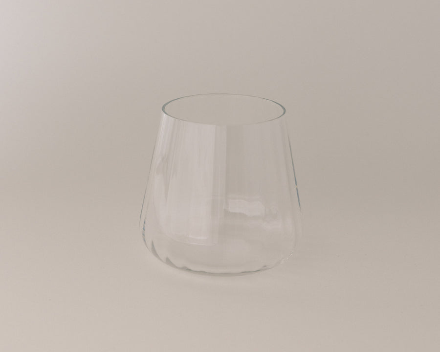 Clear glass tumbler on a beige background