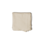 A folded light beige muslin baby blanket or swaddle with a subtle grid texture, shown on a plain white background.