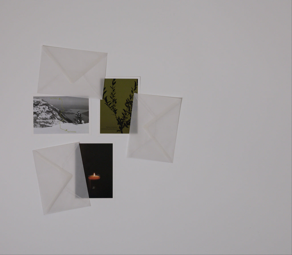 Four postcards with different images on a white background