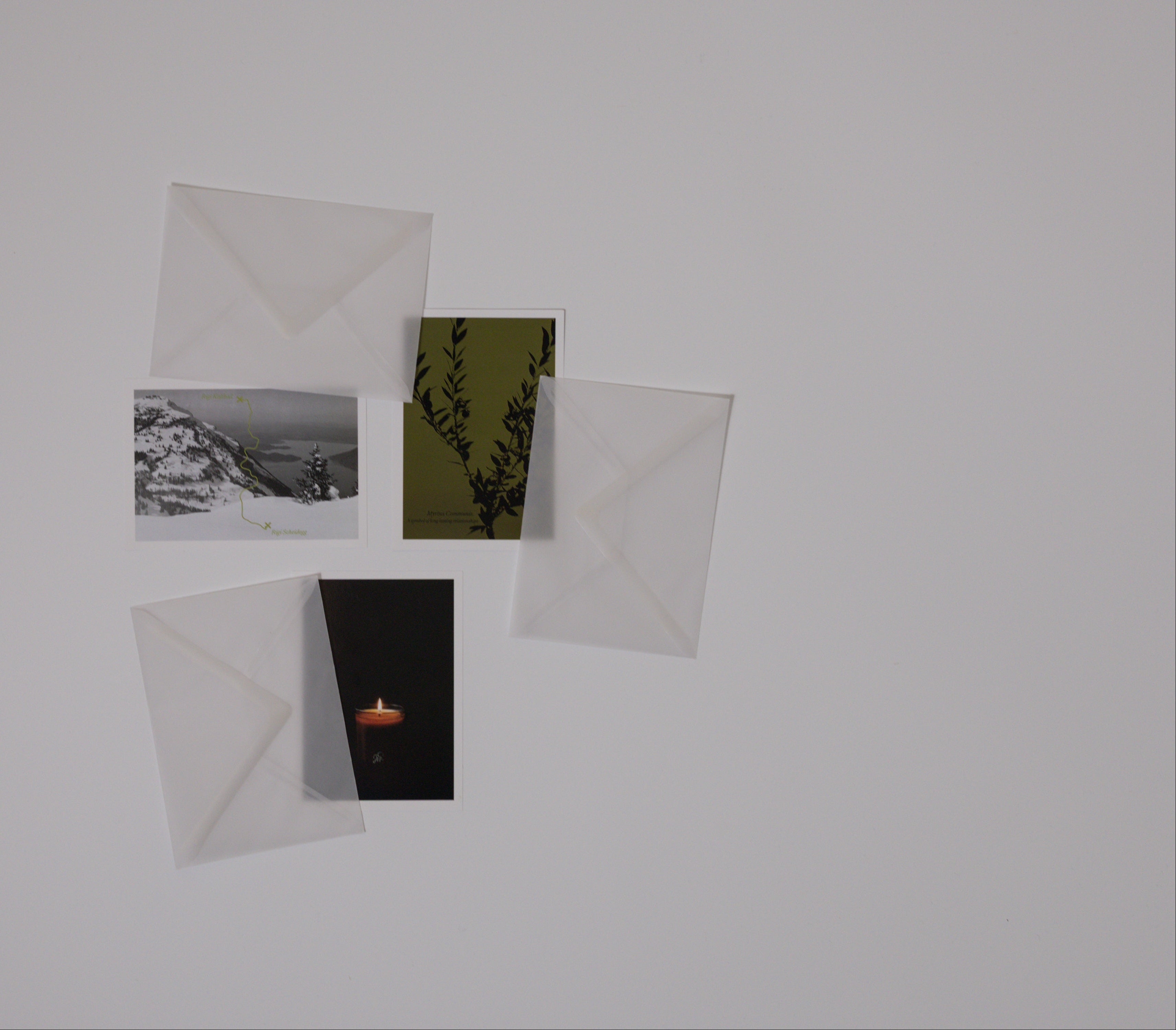 Four postcards with different images on a white background