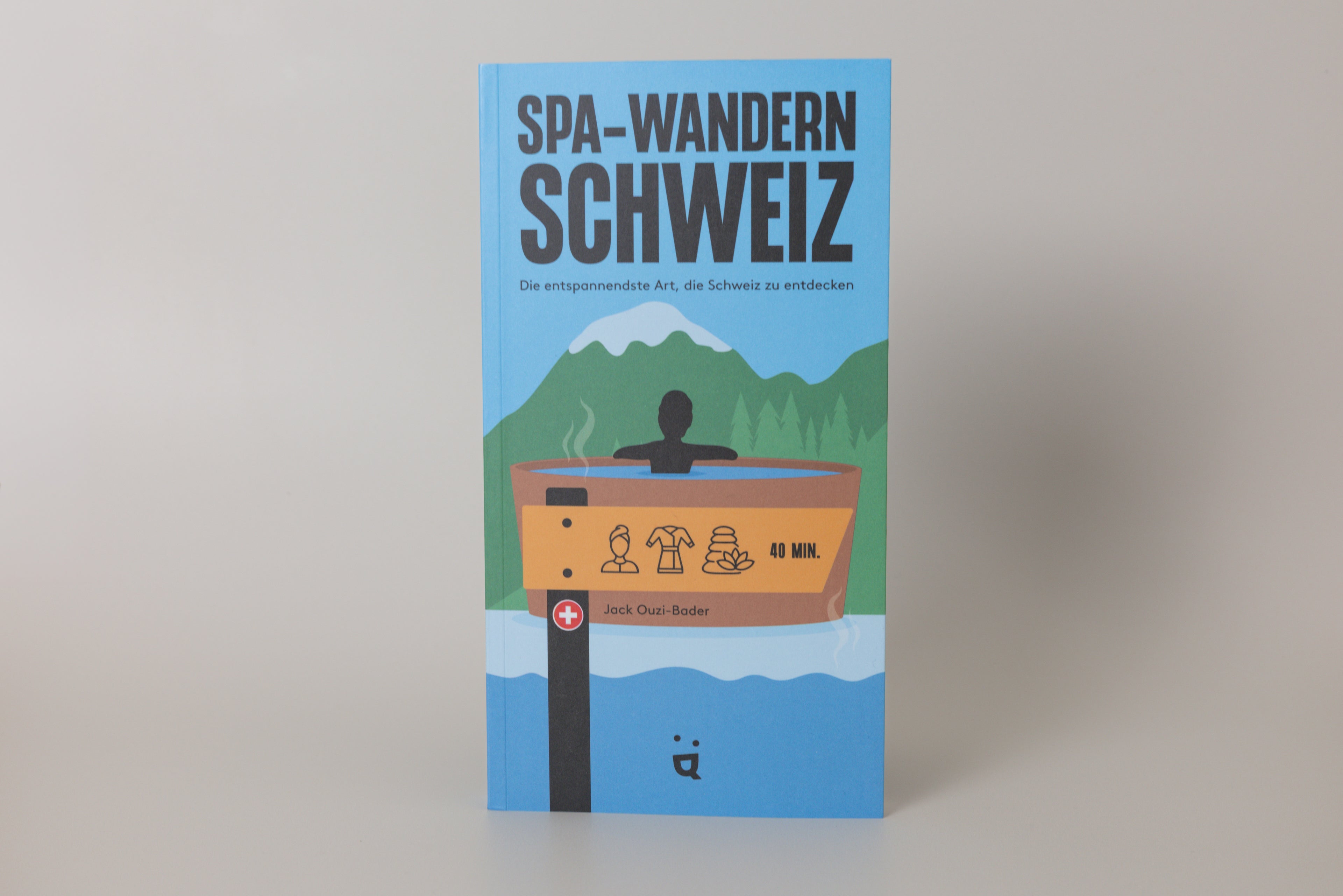 Book cover of 'Spa-Wandern Schweiz' with illustration of a person in a hot tub and mountains.