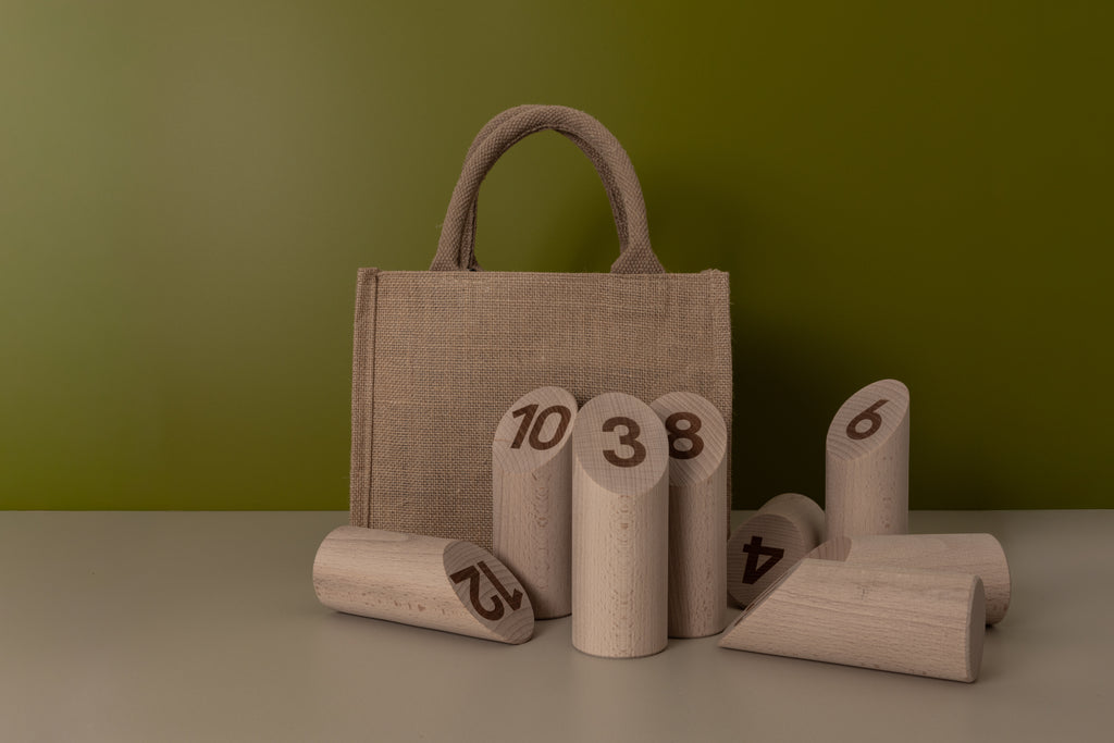 Textured bag with wooden number blocks on a green background