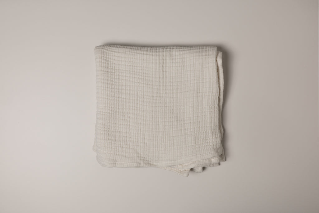 Folded muslin fabric on a plain background