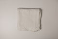 Folded muslin fabric on a plain background