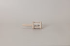 Small wooden rattle on a plain background