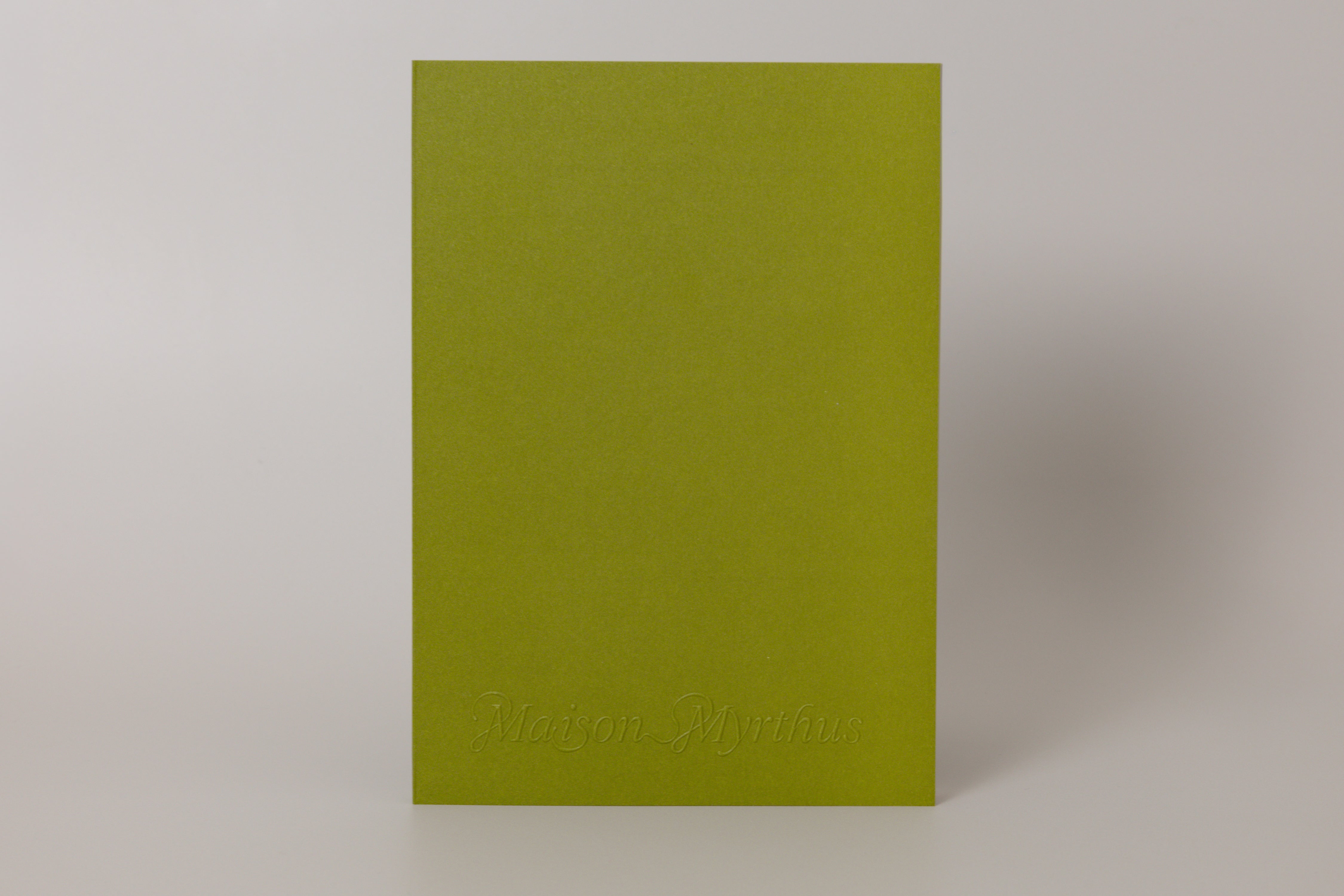 Green journal with 'Maison Myrthus' branding on a white background
