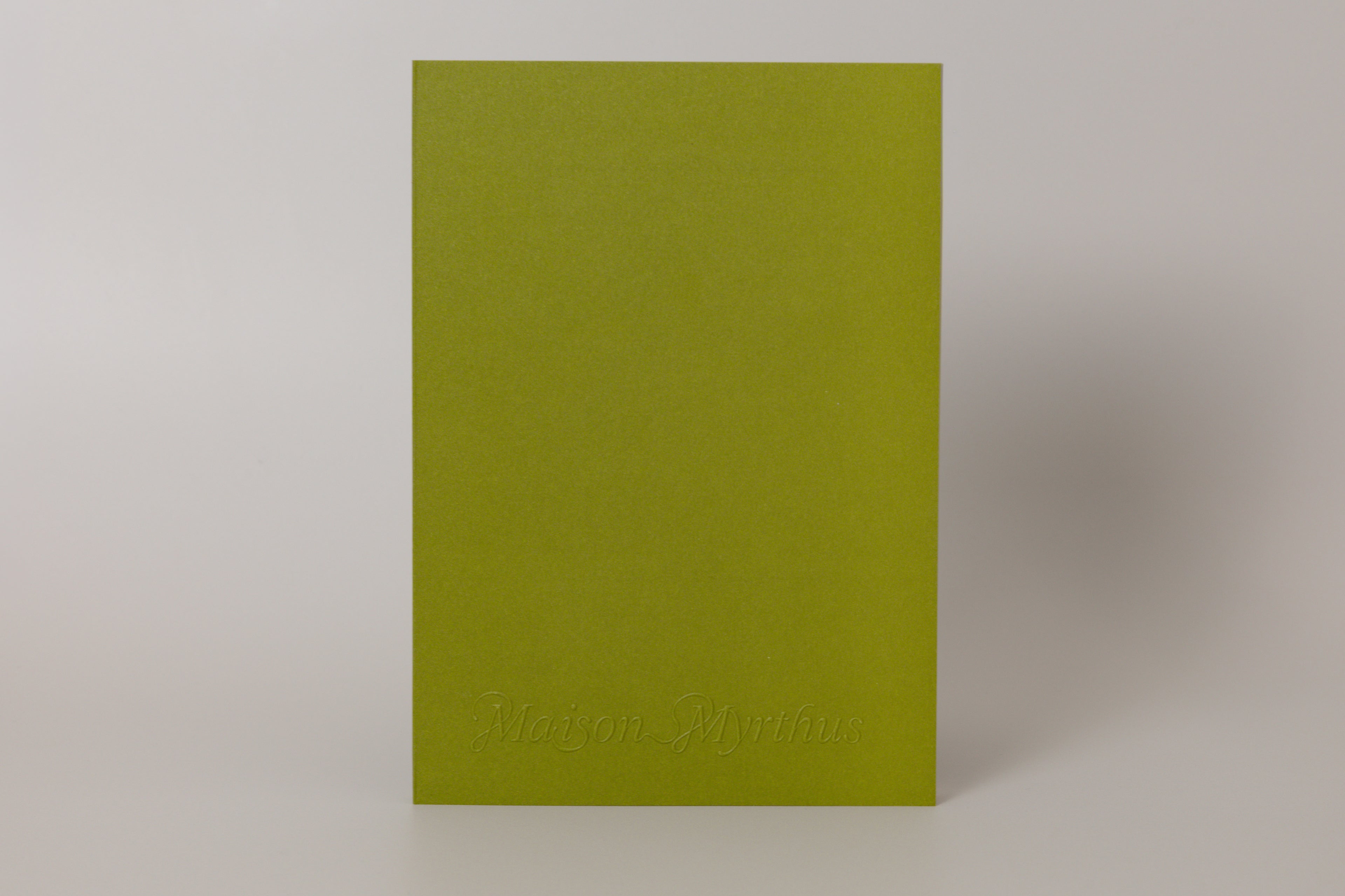 Green journal with 'Maison Myrthus' branding on a white background