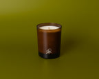 Brown candle with a logo on a green background