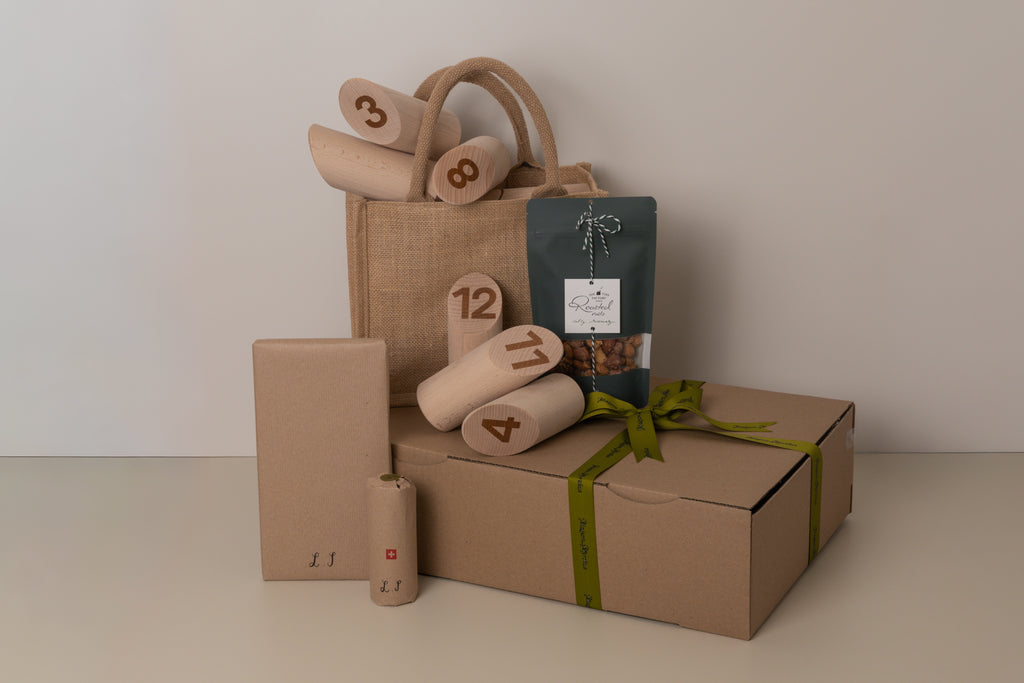 Gift set with brown paper bags, boxes, and a package on a light background