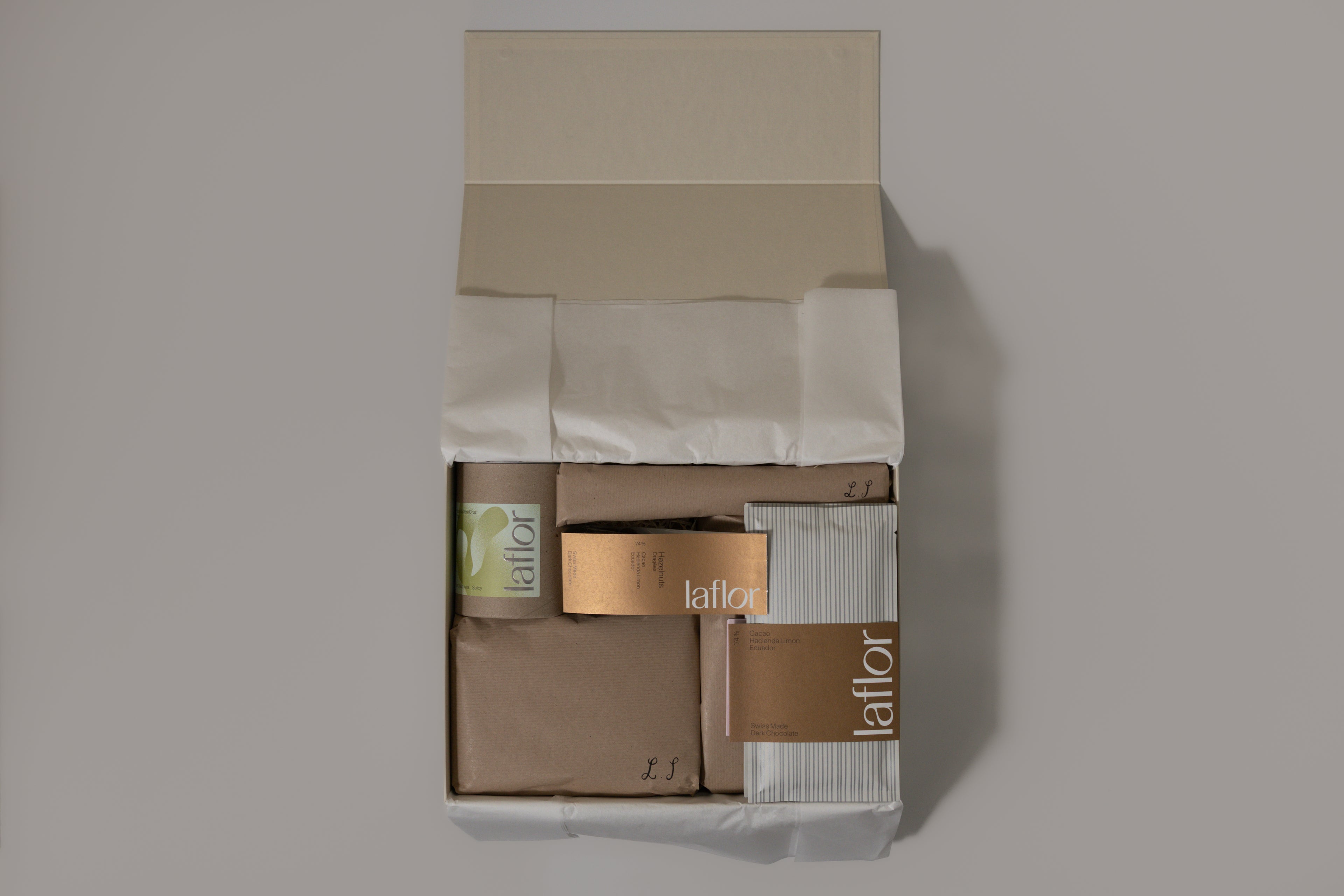 open wrapped item in premium beige box with laflor products and kraft wrapping on white background