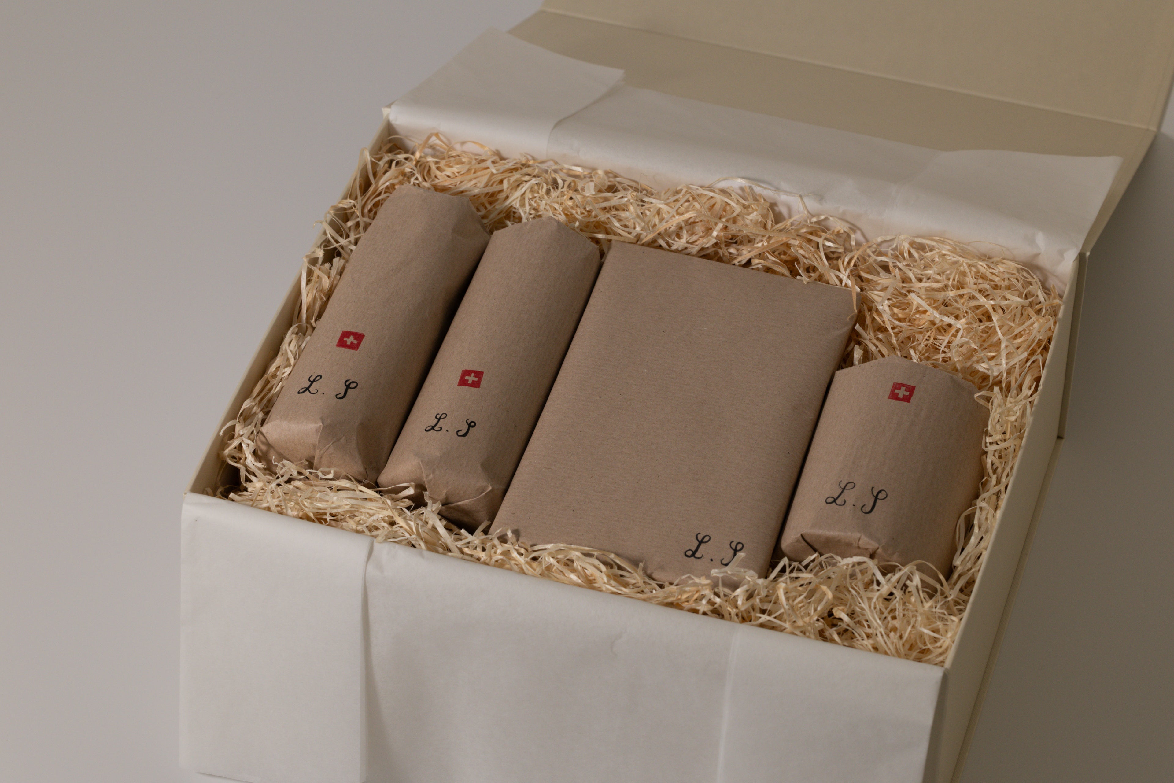 wrapped products in beige box and white background, and swiss flag